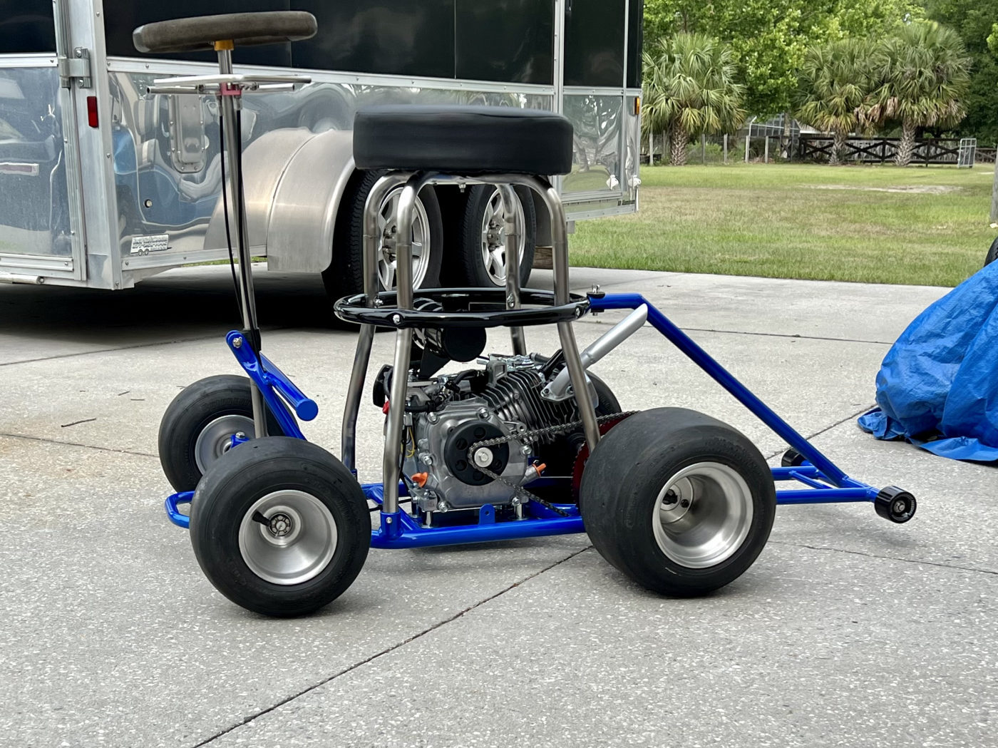 DKCC Bar-Hag — rear overhead view showing chain drive, red sprocket, Bridgestone slicks and blue frame