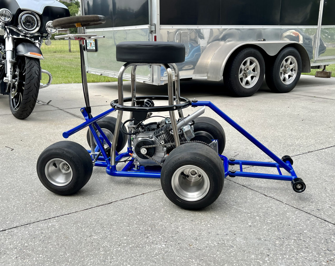 DKCC Bar-Hag — side profile outdoors showing completed build with Harley and trailer in background