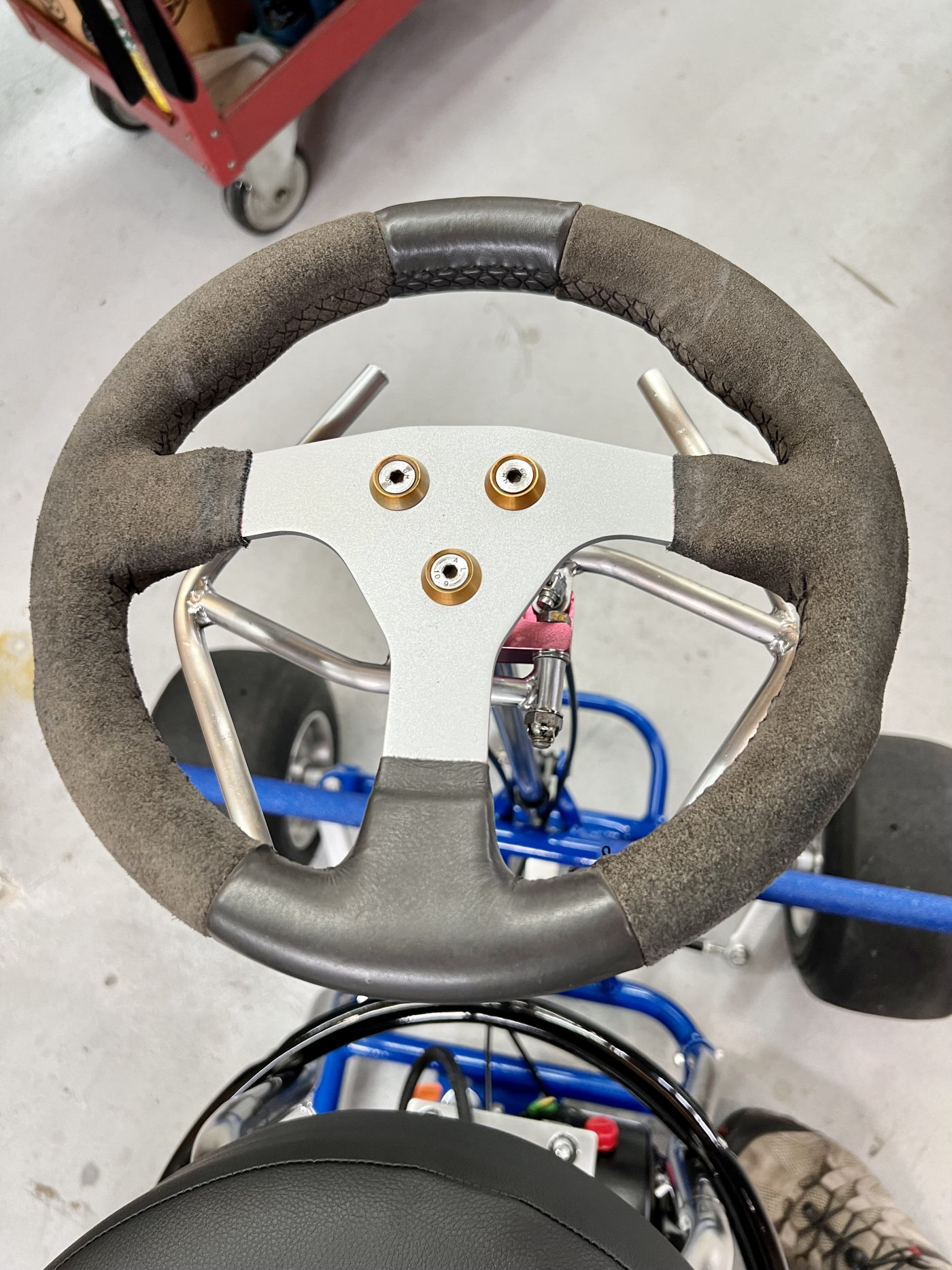 DKCC Bar-Hag — overhead shop view showing full build with suede steering wheel and Bridgestone slicks